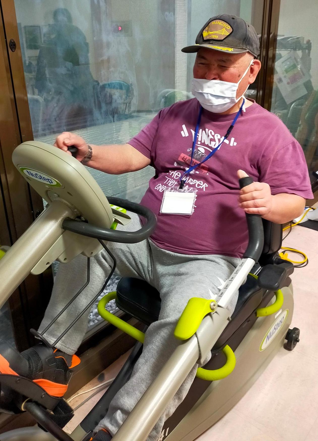 おもとパワーリハ教室。参加者の一人がトレーニングマシーンを用いて運動中。